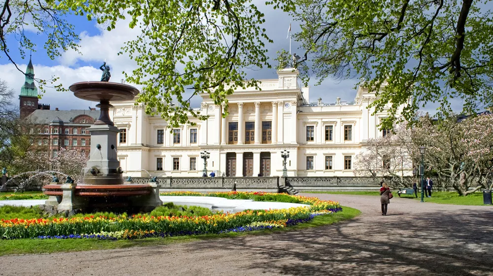 The Main University Building surrounded by spring flowers. Photo.