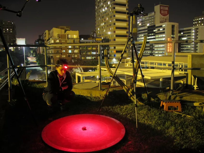 Claudia Tocco on the same night performing the same experiment at our  light-polluted site: the roof of the University of the Witwatersrand in  central Johannesburg