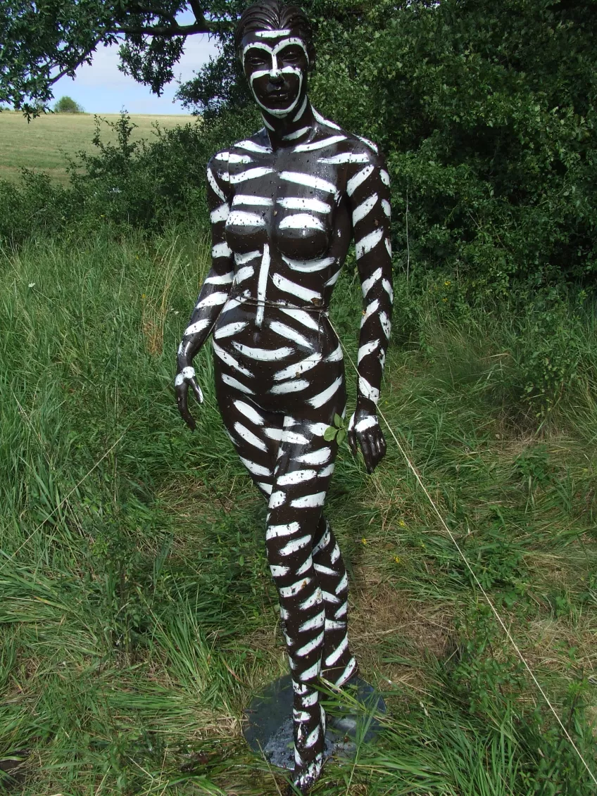 Plastic human model painted with white stripes
