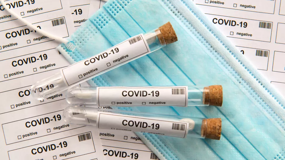 Test vials for COVID lying on a face mask