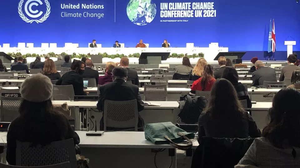 People in large room sitting at climate conference