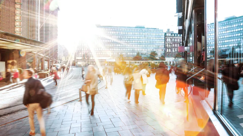 People in the street in sunshine. Photo.