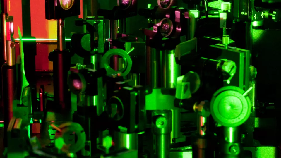 Equipment in the laser lab under green laser light