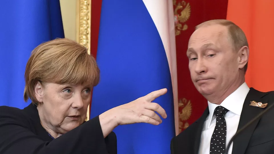 Angela Merkel gestures as Vladimir Putin looks on. Photo: Kirill Kudryavtsev/Reuters.