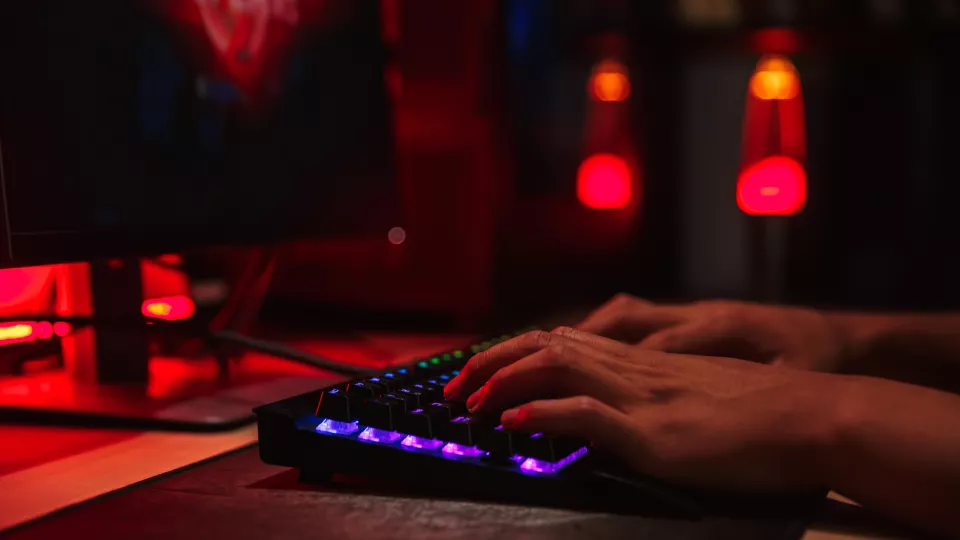 Hands on keyboard in dark room