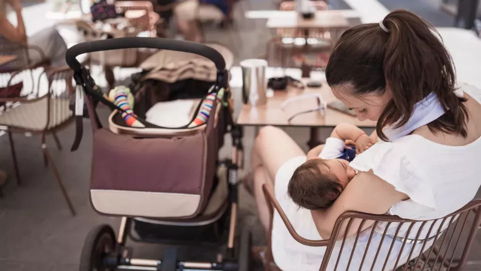 Woman breastfeeding in a cafe