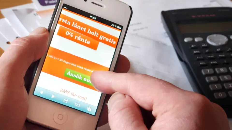 Mobile phone showing website offering quick loans