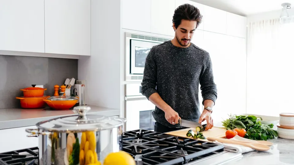 Man chopping food in a kitchen