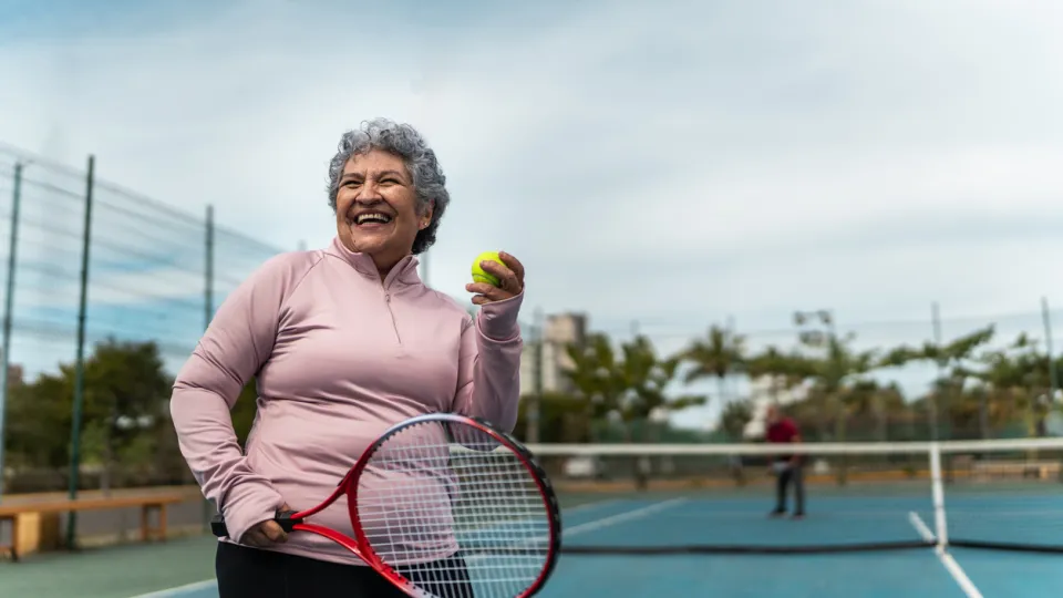 Senior woman playing tennis at sports court Photo: iStock