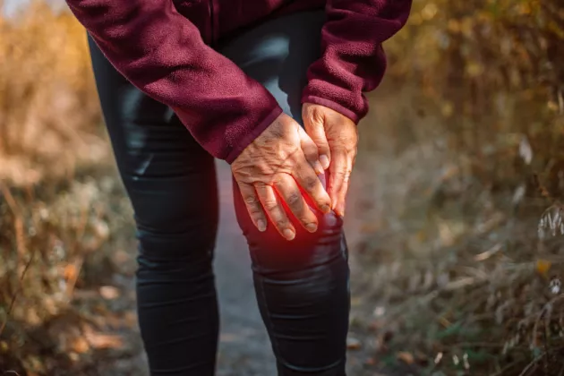 Woman holding her knee