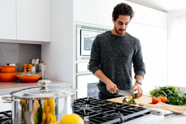 Man chopping food in a kitchen