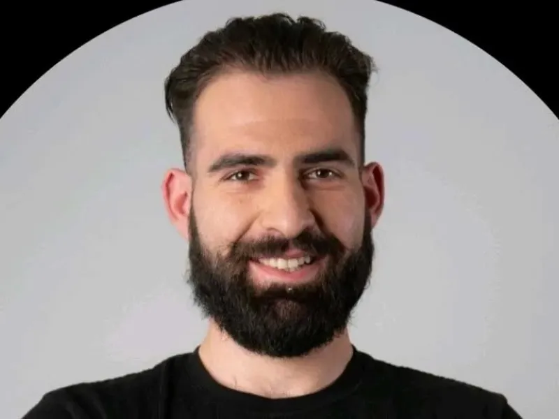 Portrait photo of a man and gray background.