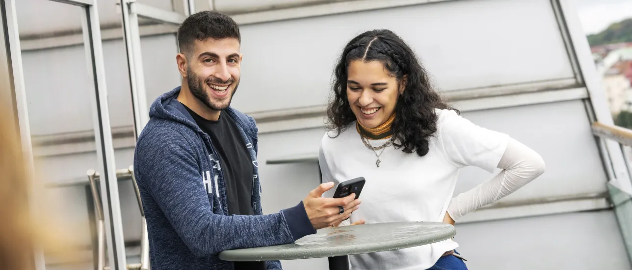 Two students looking at a telephone.