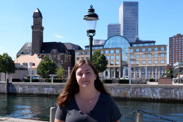 Alumna Audrey standing by the canal in Malmö town. Photo.