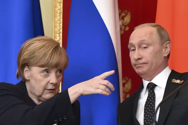 Angela Merkel gestures as Vladimir Putin looks on. Photo: Kirill Kudryavtsev/Reuters.