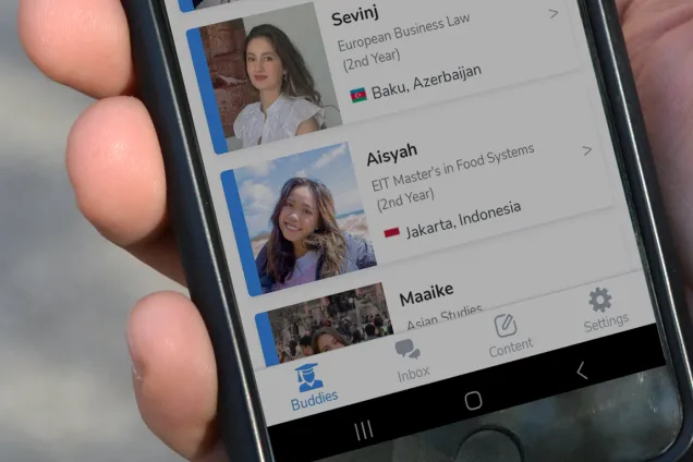 A hand holding a phone with the open Unibuddy app. Photo. 