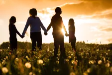 Family at sunset holding hands