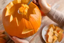 Close-up of a pumpkin being carved