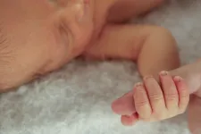 A baby gripping an adult finger. Photo: iStock