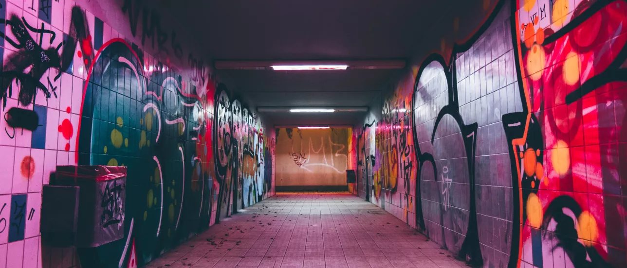 A tunnel painted with graffiti. Photo.