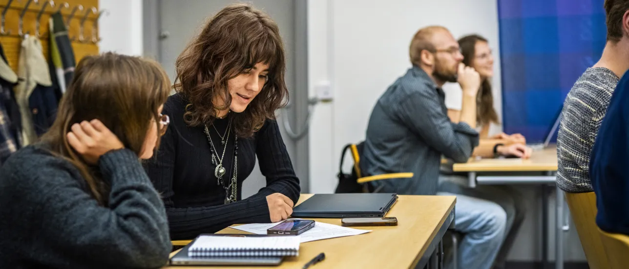 Students in a small classroom at SOL.