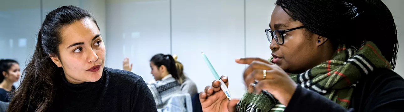 Two students of public health talking during a class. Photo: Kennet Ruona.