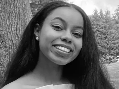 Black and white portrait photo of a woman smiling.