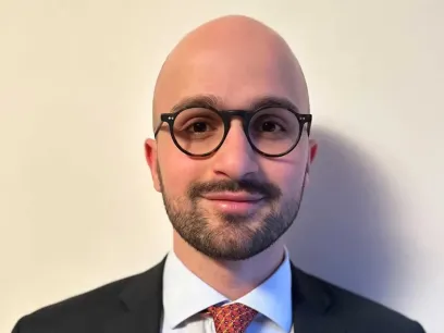 Portrait photo of a man towards a white background.