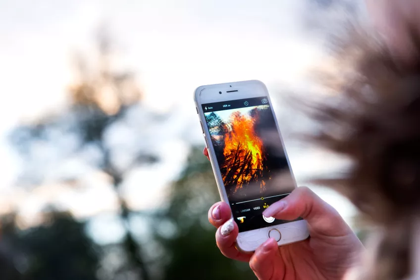 The Valborg bonfire of Lund seen on a phone screen
