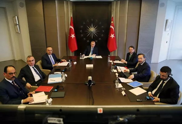 Turkish president Erdogan at a table with his advisors